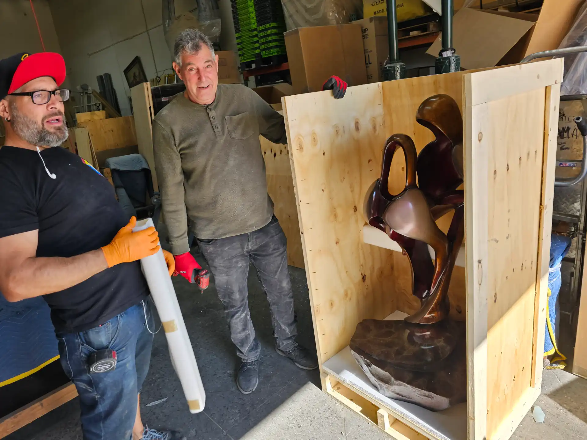 Staff crating a bronze sculpture for shipment